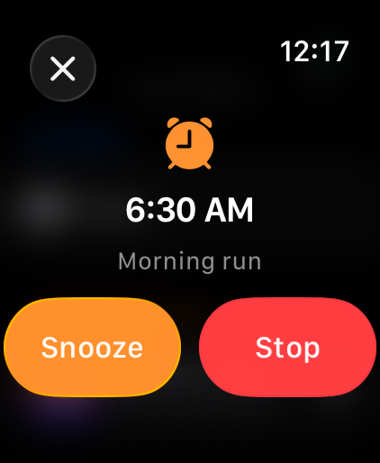 A 6:30 AM alarm ringing on the watch with Snooze and Stop