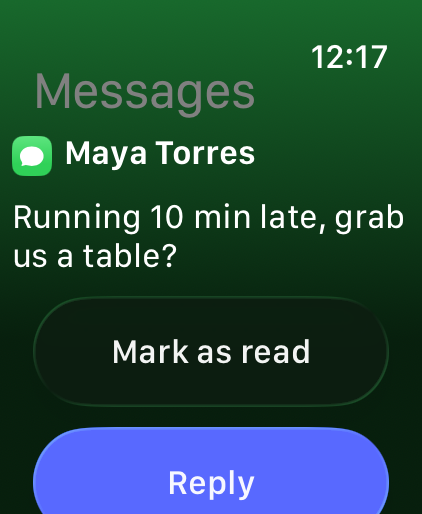 A text message on the watch with Mark as read and Reply
